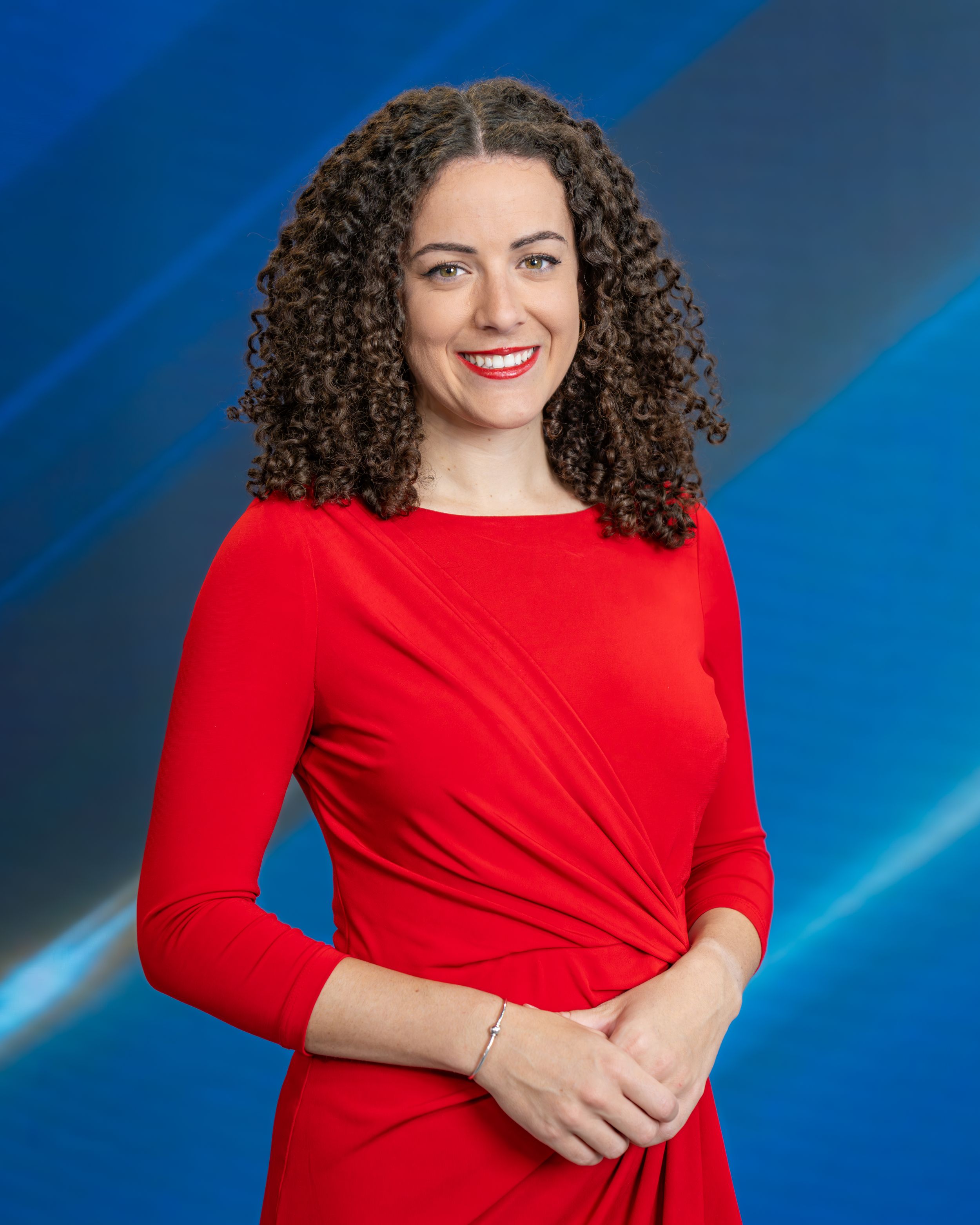 A series of professional headshots showing a person in a bright red top against a blue studio background with dramatic lighting.