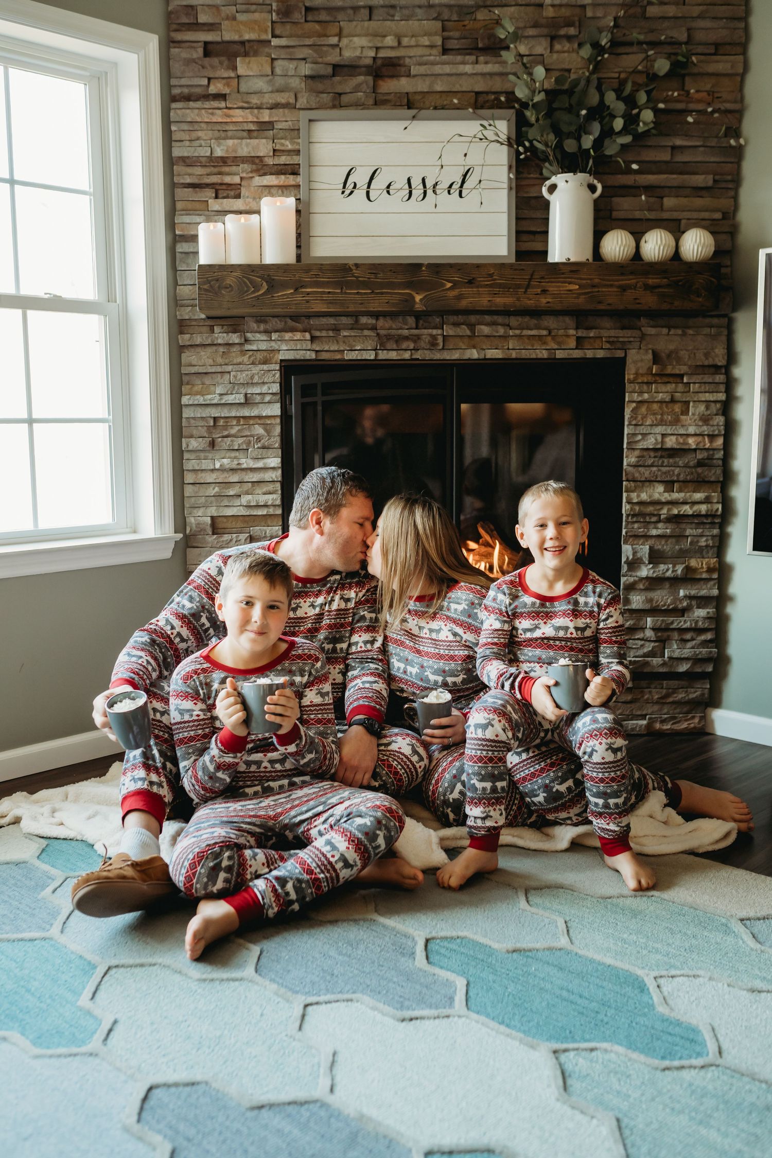 A couple embraces intimately in a rustic cabin decorated with twinkling string lights and holiday decorations.