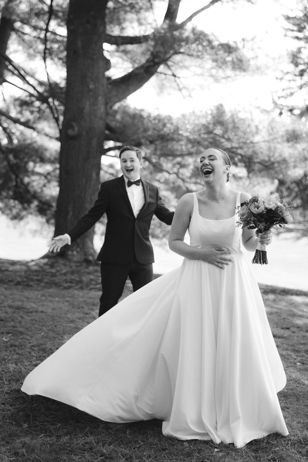 Black and white sequence of a couple in wedding attire playfully twirling and dancing in a park setting.