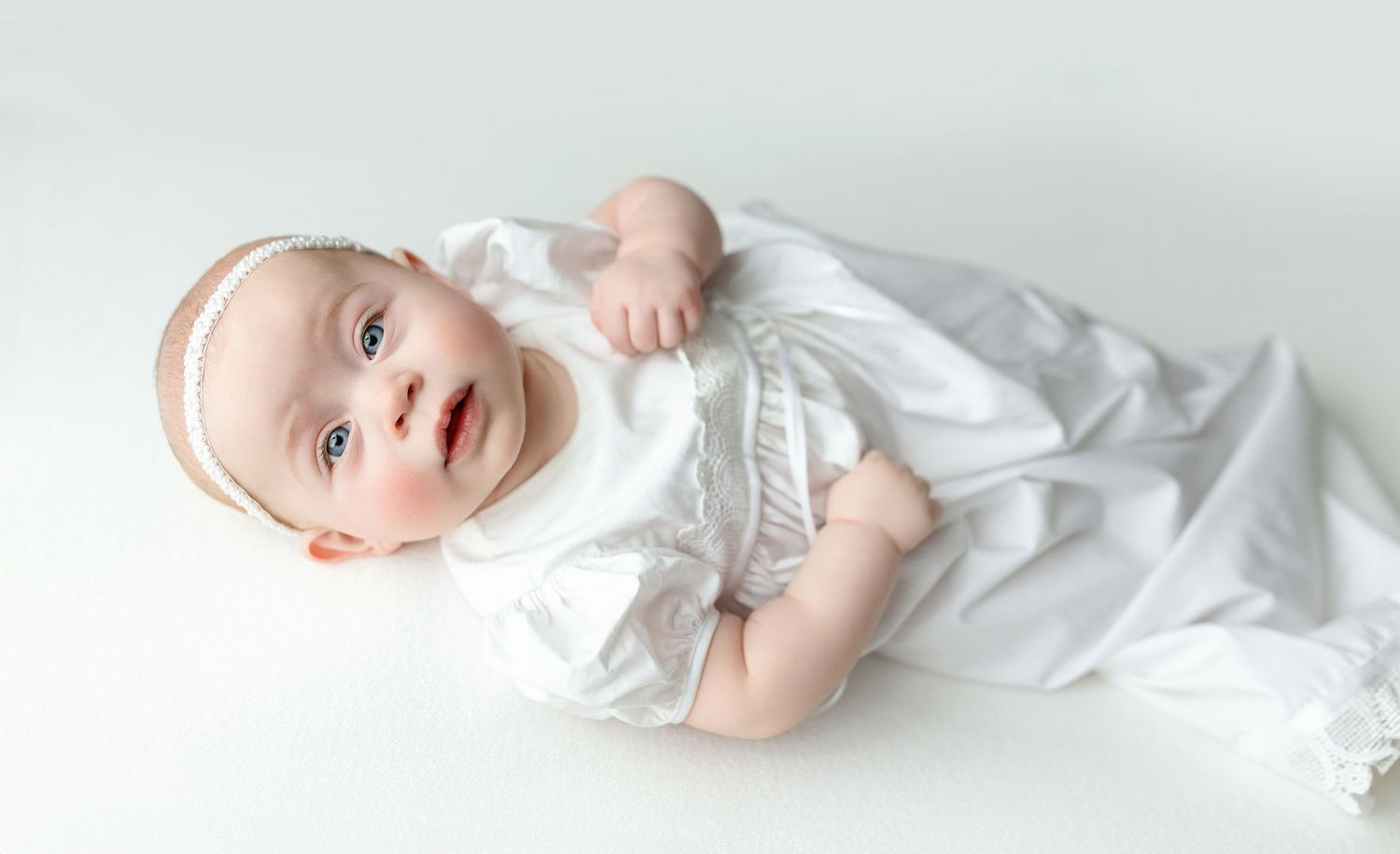 A baby girl in a white dress. Greenville SC newborn photographer, Easley SC newborn photographer, Upstate newborn photographer