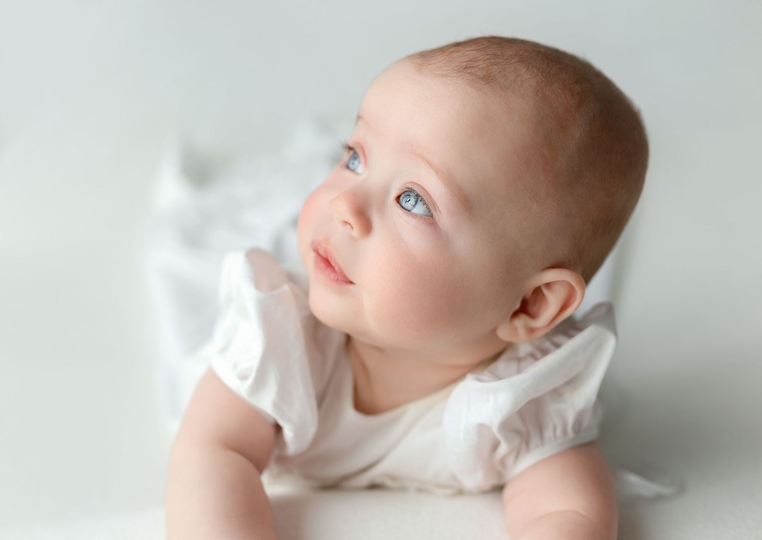 A baby girl in a white dress. Greenville SC newborn photographer, Easley SC newborn photographer, Upstate newborn photographer