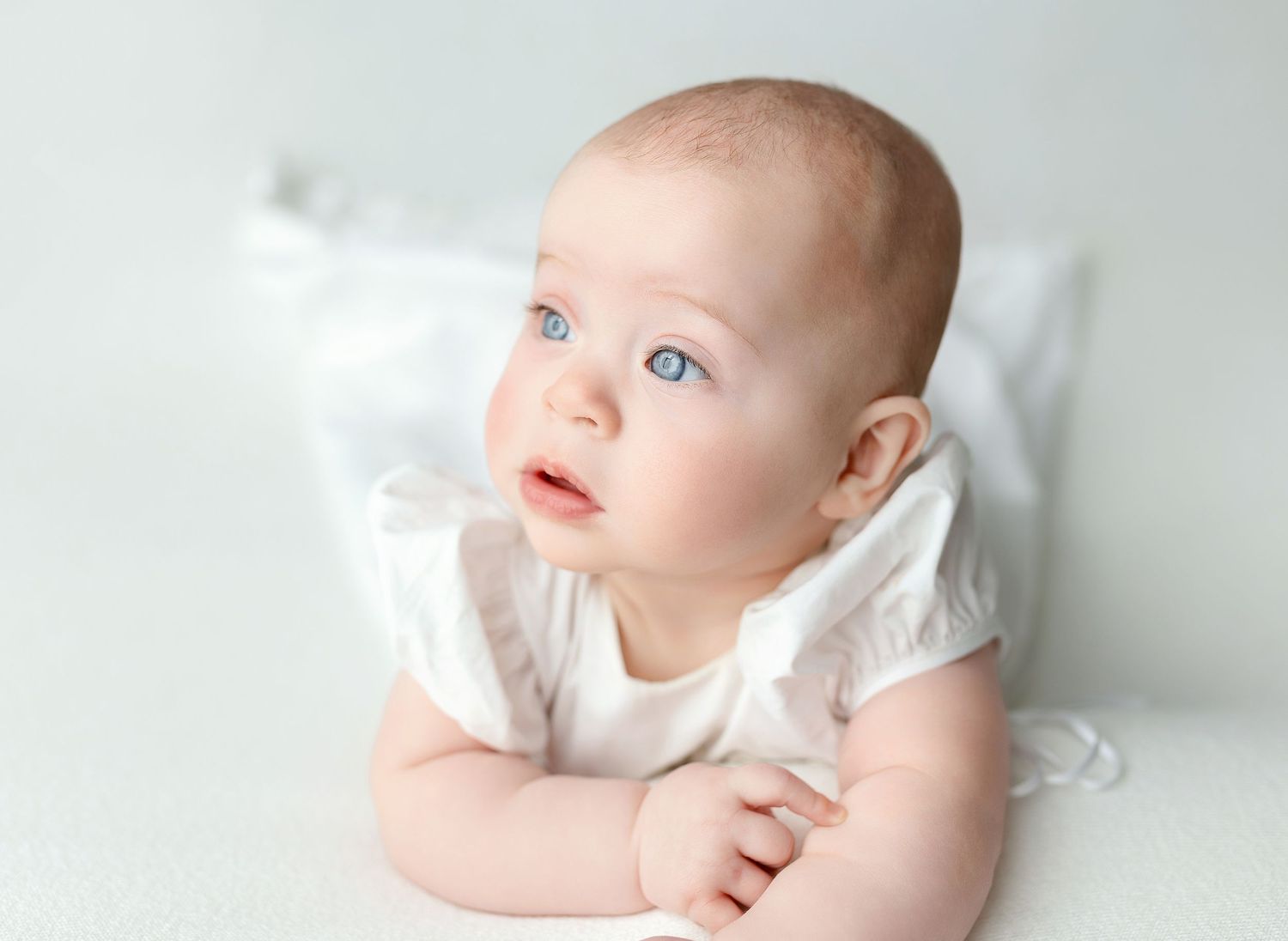A baby girl in a white dress. Greenville SC newborn photographer, Easley SC newborn photographer, Upstate newborn photographer