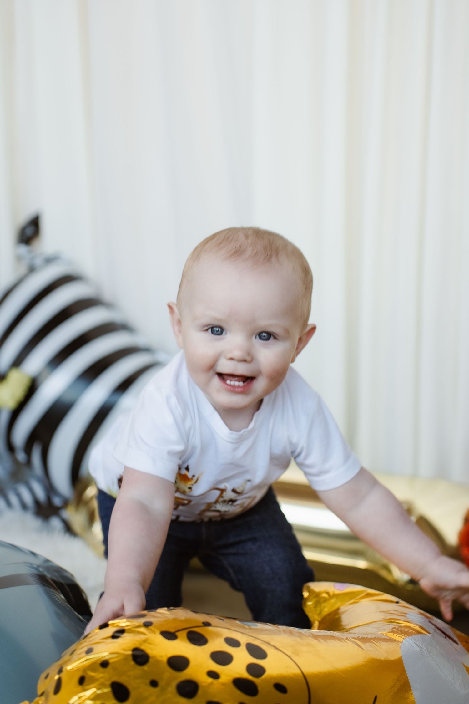 Model demonstrating product cards while wearing brown striped outfit in studio setting.