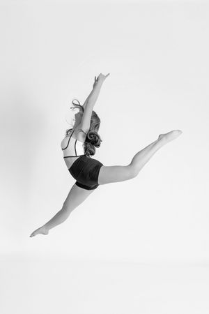 Professional dance portrait in Ridgefield CT studio with controlled lighting and minimalist backdrop focusing on movement and form Ballet