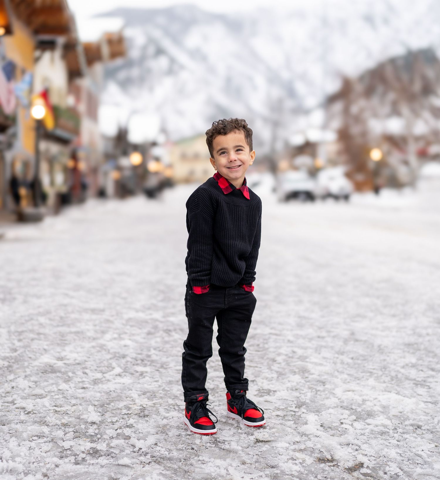 A sequence of five photos showing someone walking in winter weather wearing black pants and red sneakers. Leavenworth, WA