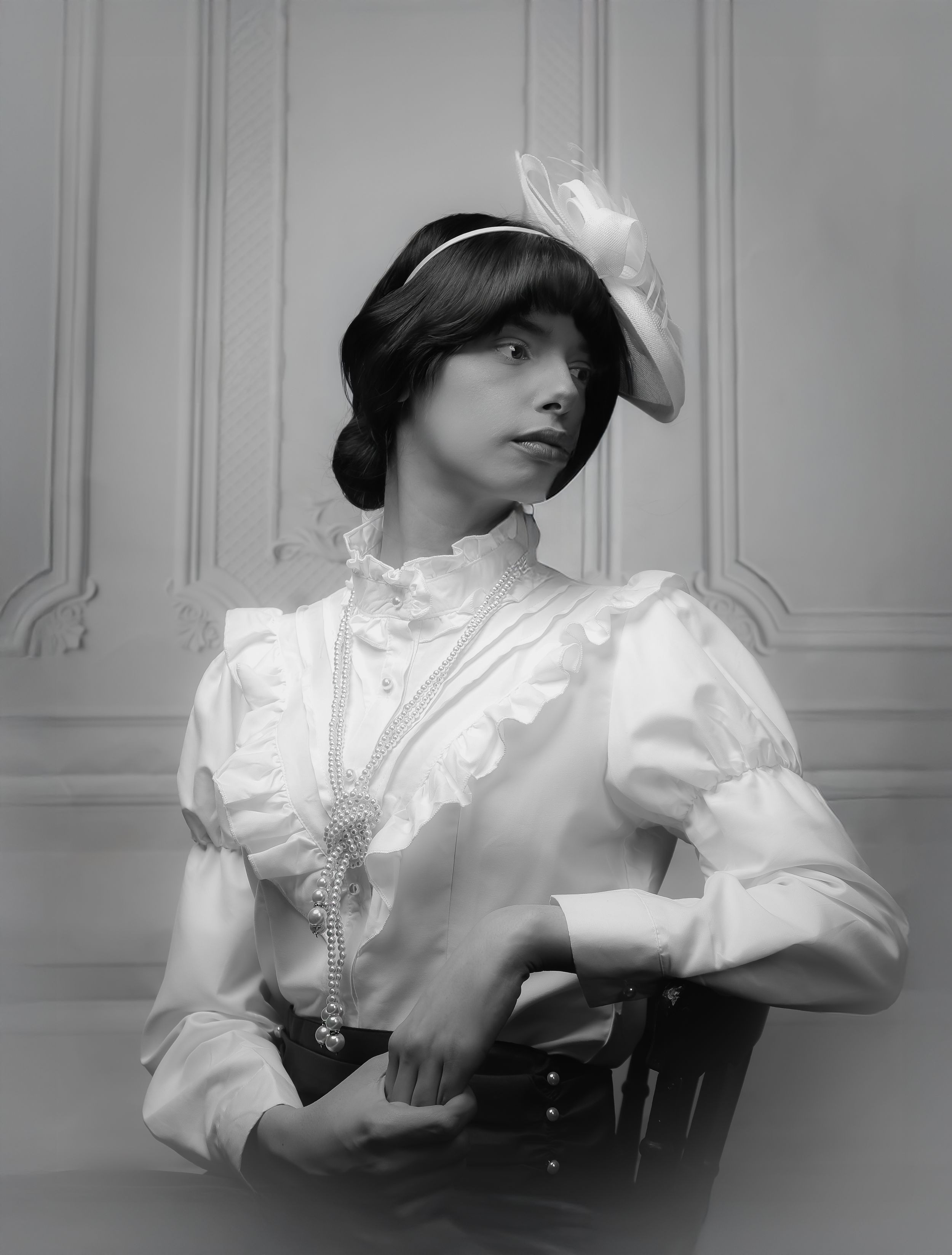 Black and white photo of a girl in a Victorian, edwardian dress - turned looking to the right