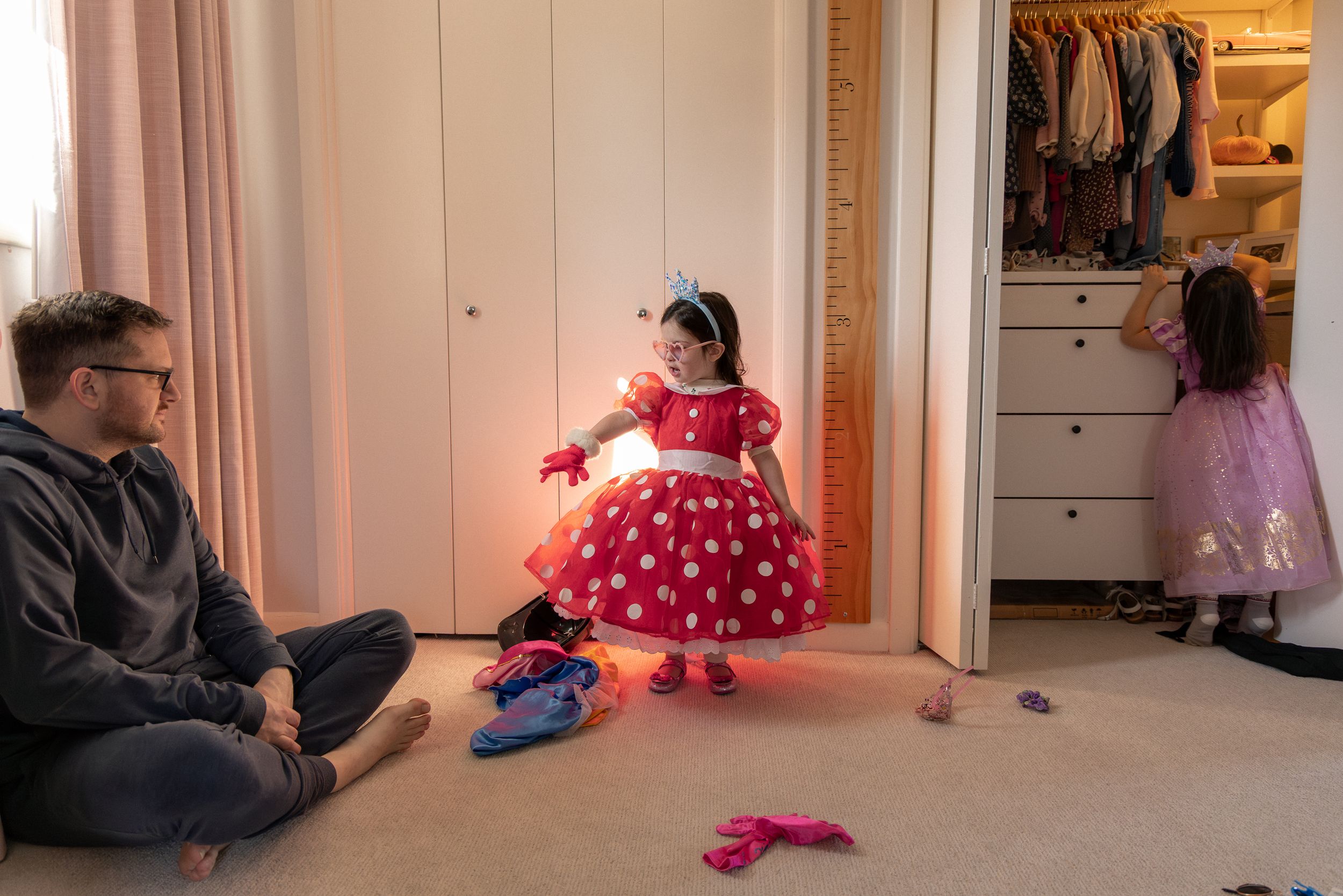 A sequence of images shows a small child in a red dress walking down a hallway with changing lighting conditions.