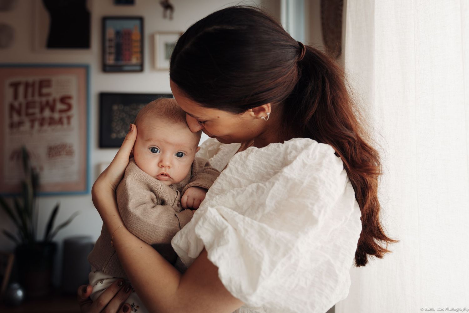 Intimate indoor family moment captured in soft natural light.