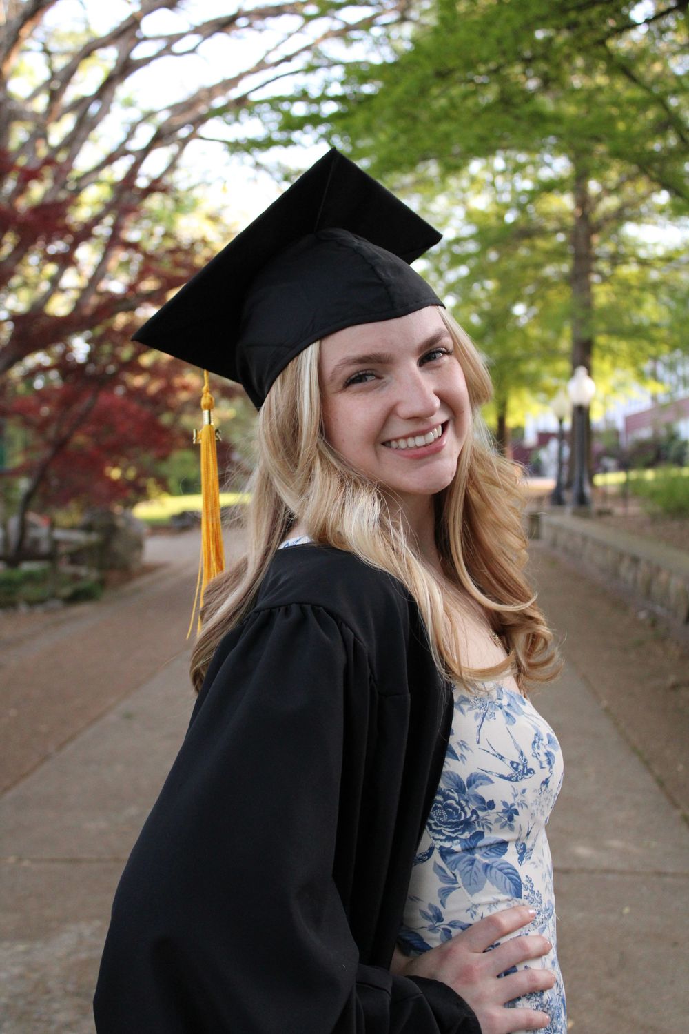 girl smiling wearing graduation clothes