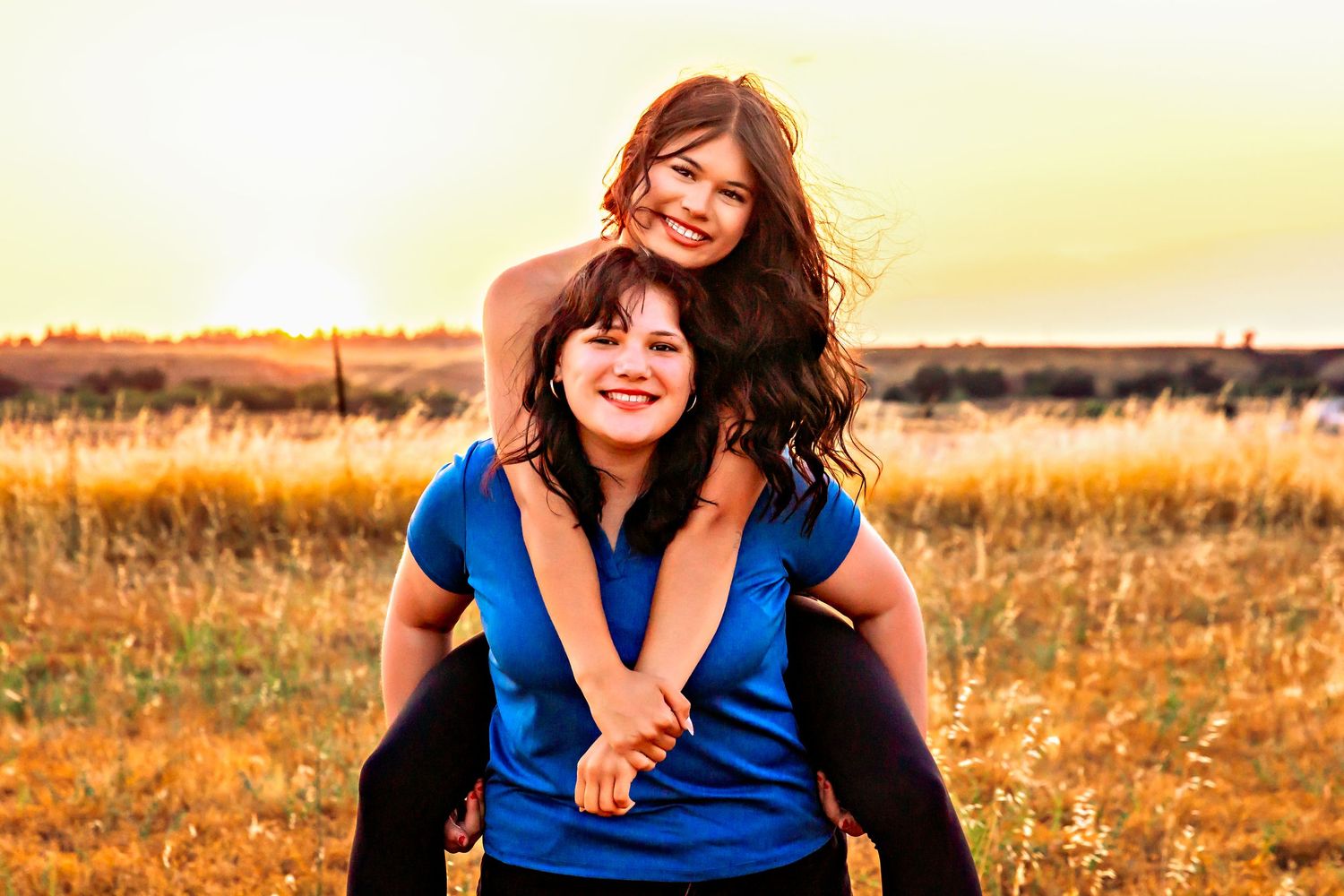 sisters captured bonding as the wind makes a stop and the golden hour is magic in fresno,ca