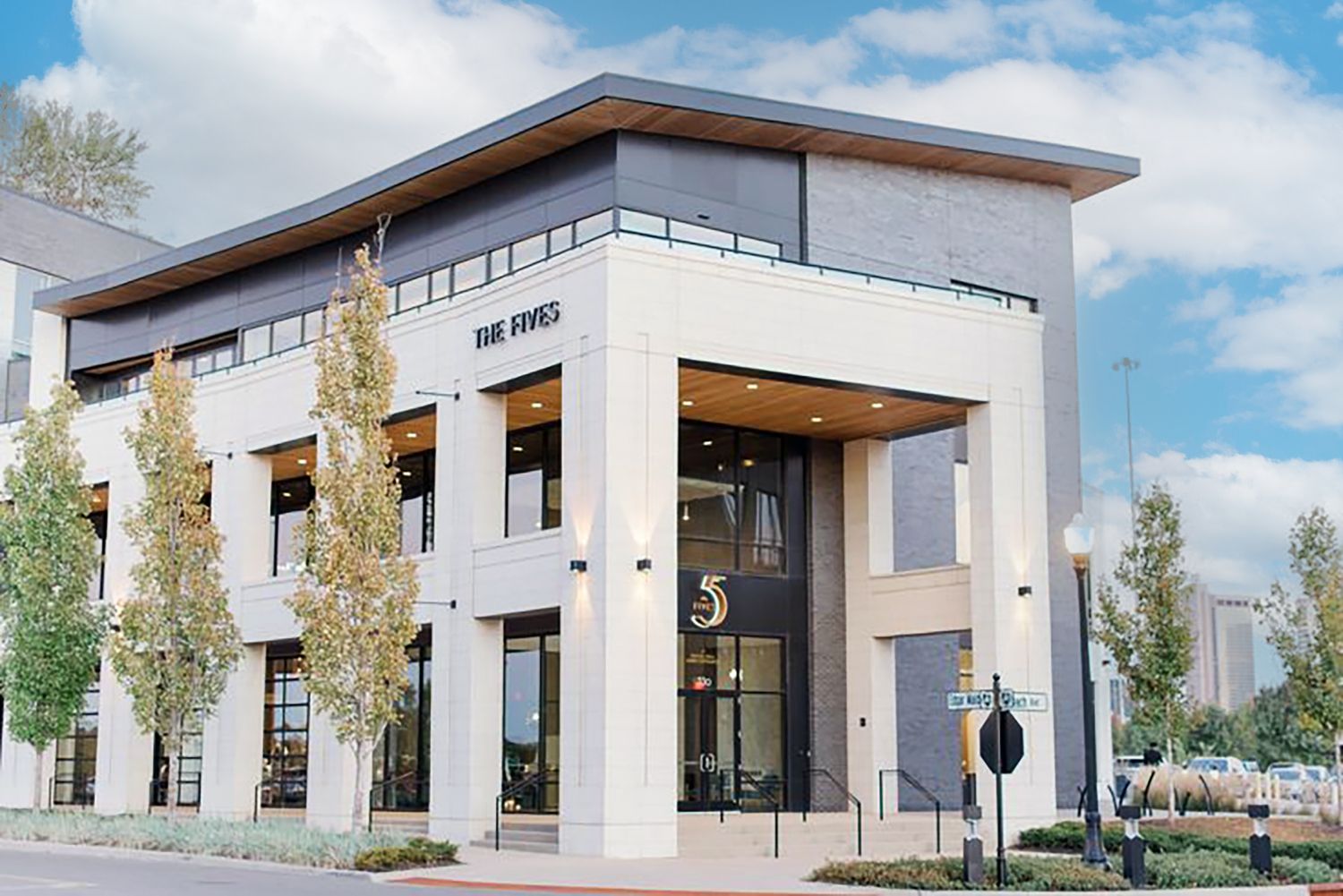Modern white church or event venue exterior with clean architectural lines and landscaped grounds.