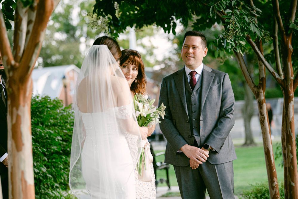 Outdoor wedding ceremony photos showing couple among trees and greenery.