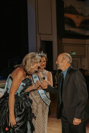 A sequence of candid moments at a formal event showing people interacting and embracing in a dimly lit venue.