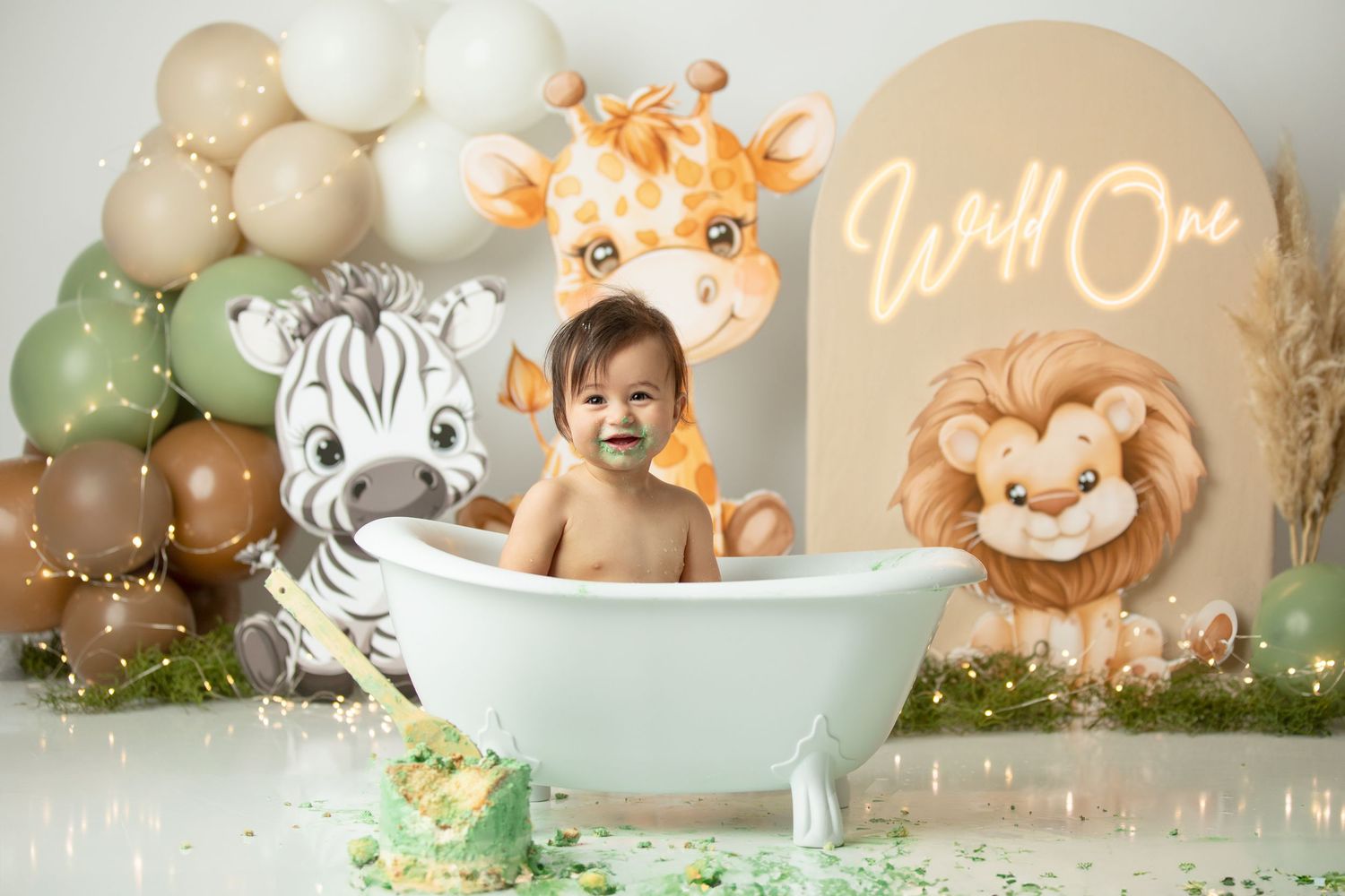 First birthday cake smash photography Springfield Lakes studio – wild one jungle theme with green cake.