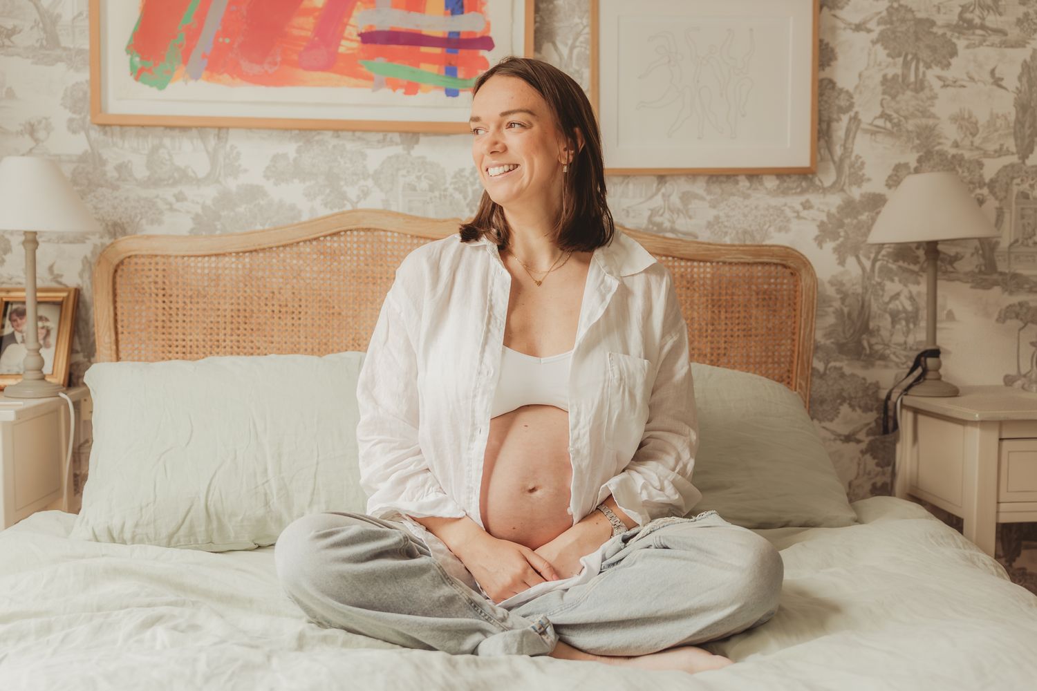 Intimate maternity photography session with natural lighting and neutral tones.