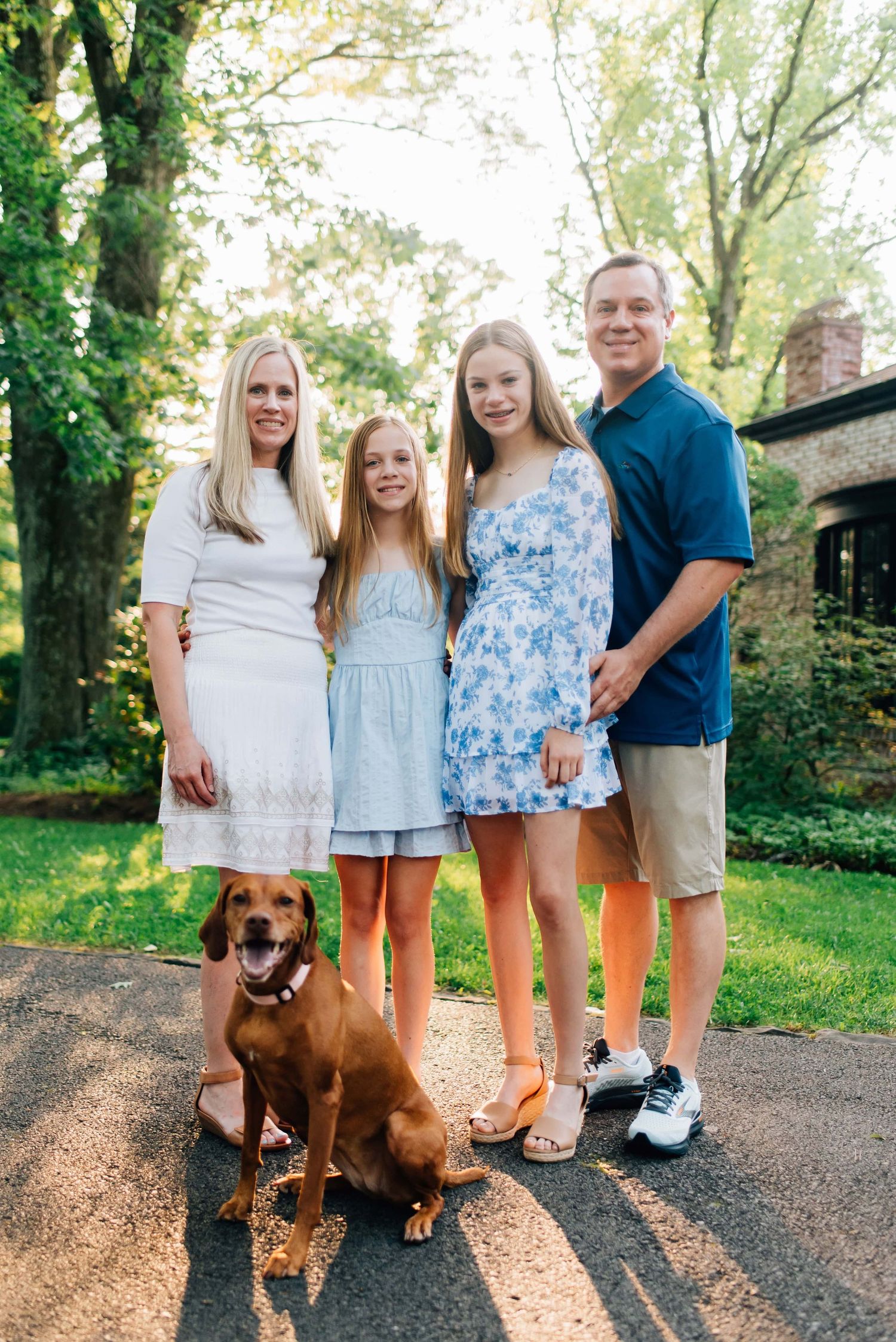 Family smiling at camera for summer photos at Succop Nature Park in Butler, PA