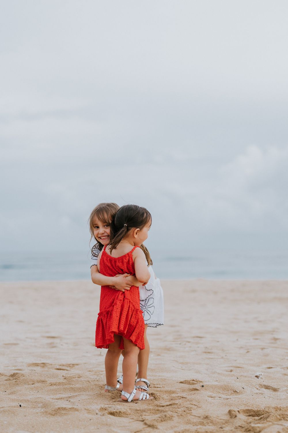 Beach family photography in Bali with an 
ocean backdrop