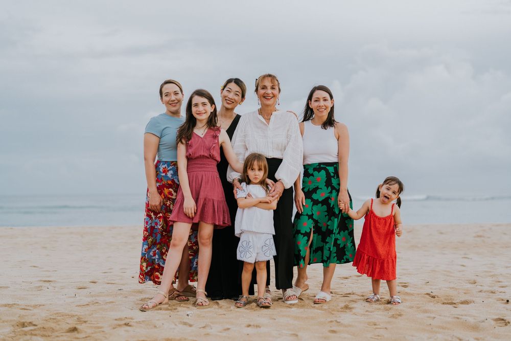 Beach family photography in Bali with an 
ocean backdrop