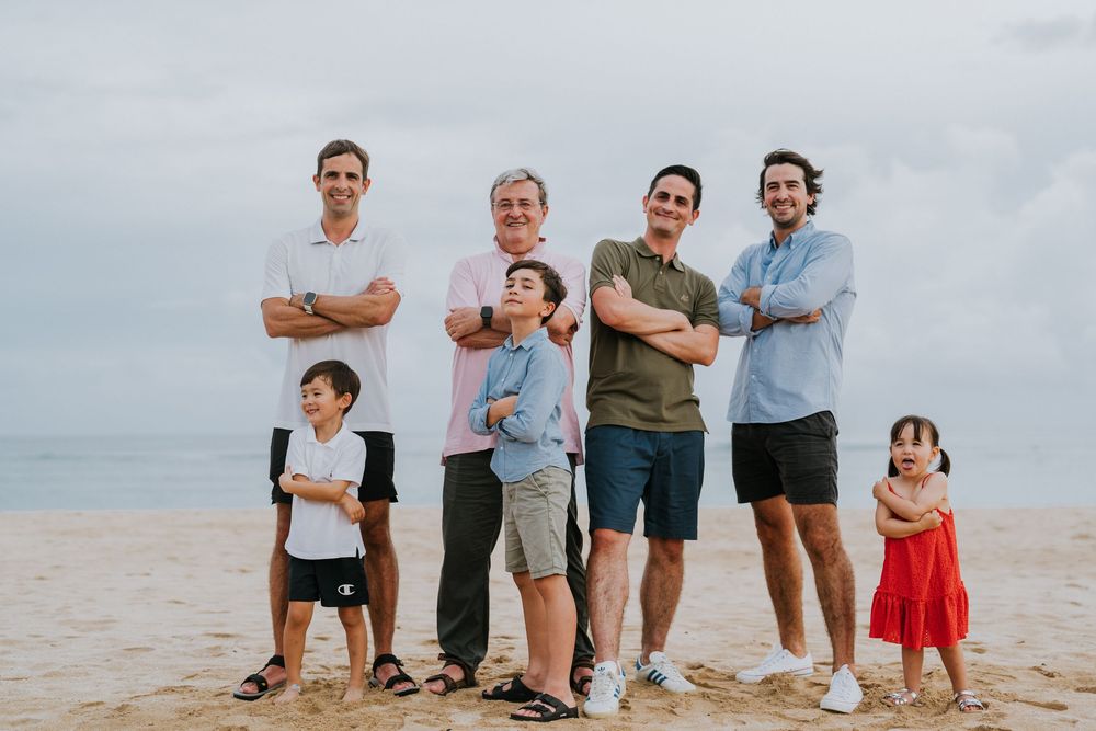 Beach family photography in Bali with an 
ocean backdrop