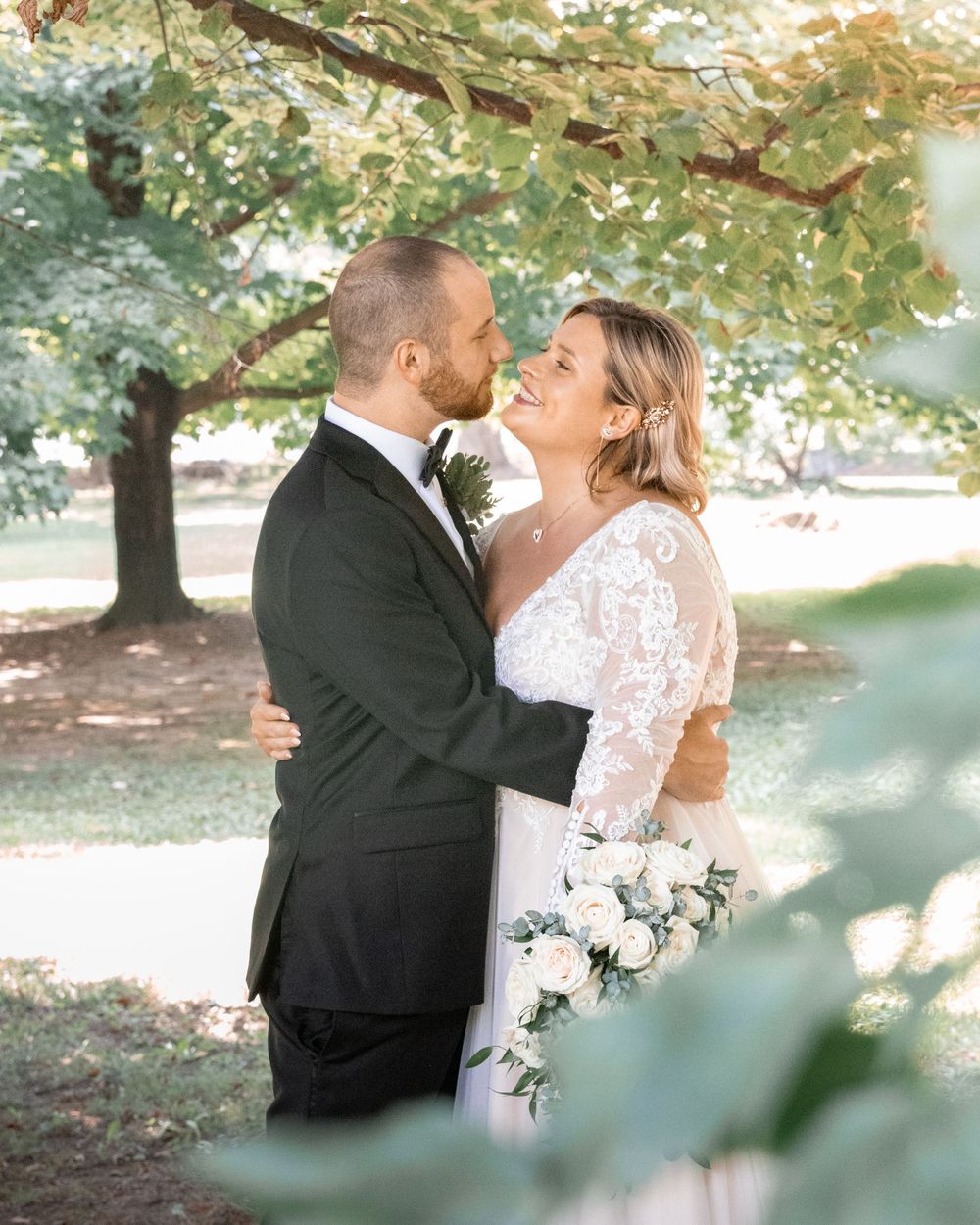A romantic wedding photo sequence showing a couple embracing under trees with soft natural lighting.