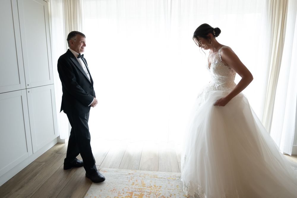 A series of artistic black and white wedding photos showing intimate moments between the couple in a bright room.