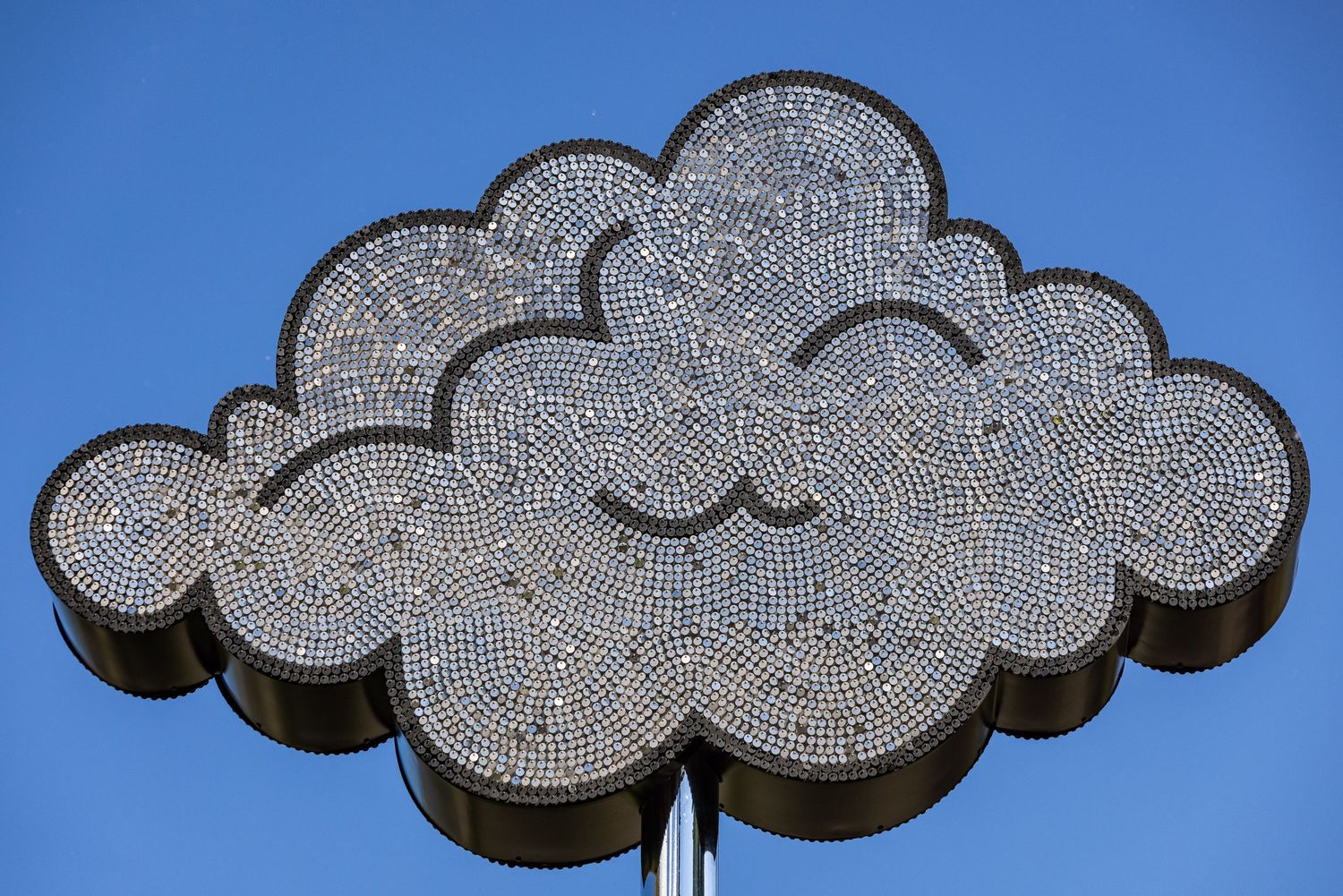 Decorative cloud-shaped LED light fixtures mounted on a blue wall create an illuminated celestial display.