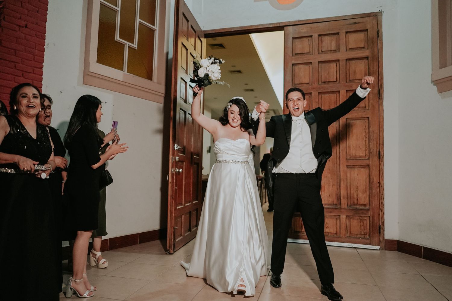 A sequence of dance moves captured in a wedding venue with wooden doors and white walls in the background.