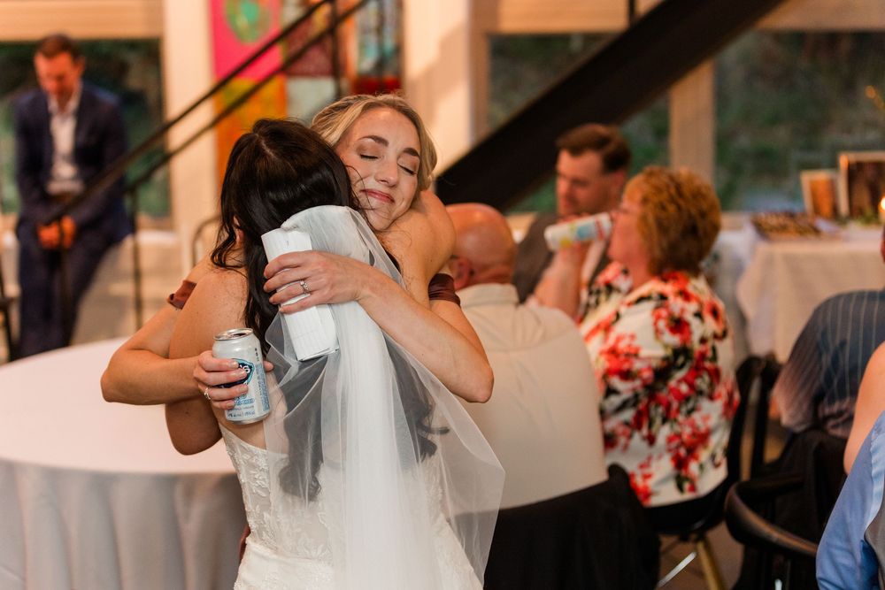 A group of wedding guests dance and celebrate together at a lively reception party.