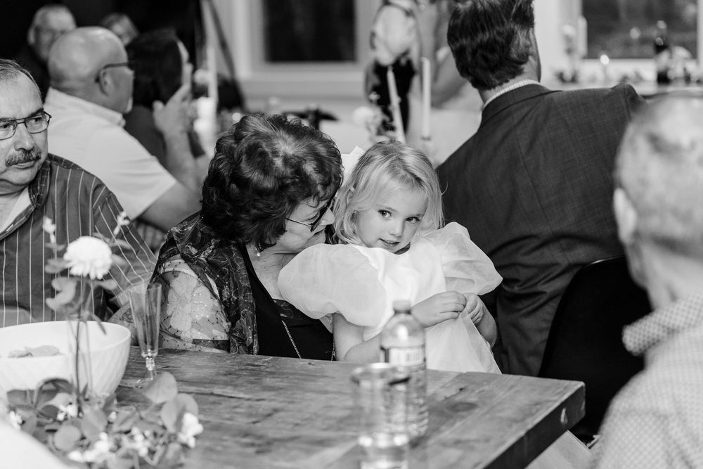 A black and white photo collage showing multiple wedding reception scenes with guests dining and celebrating.