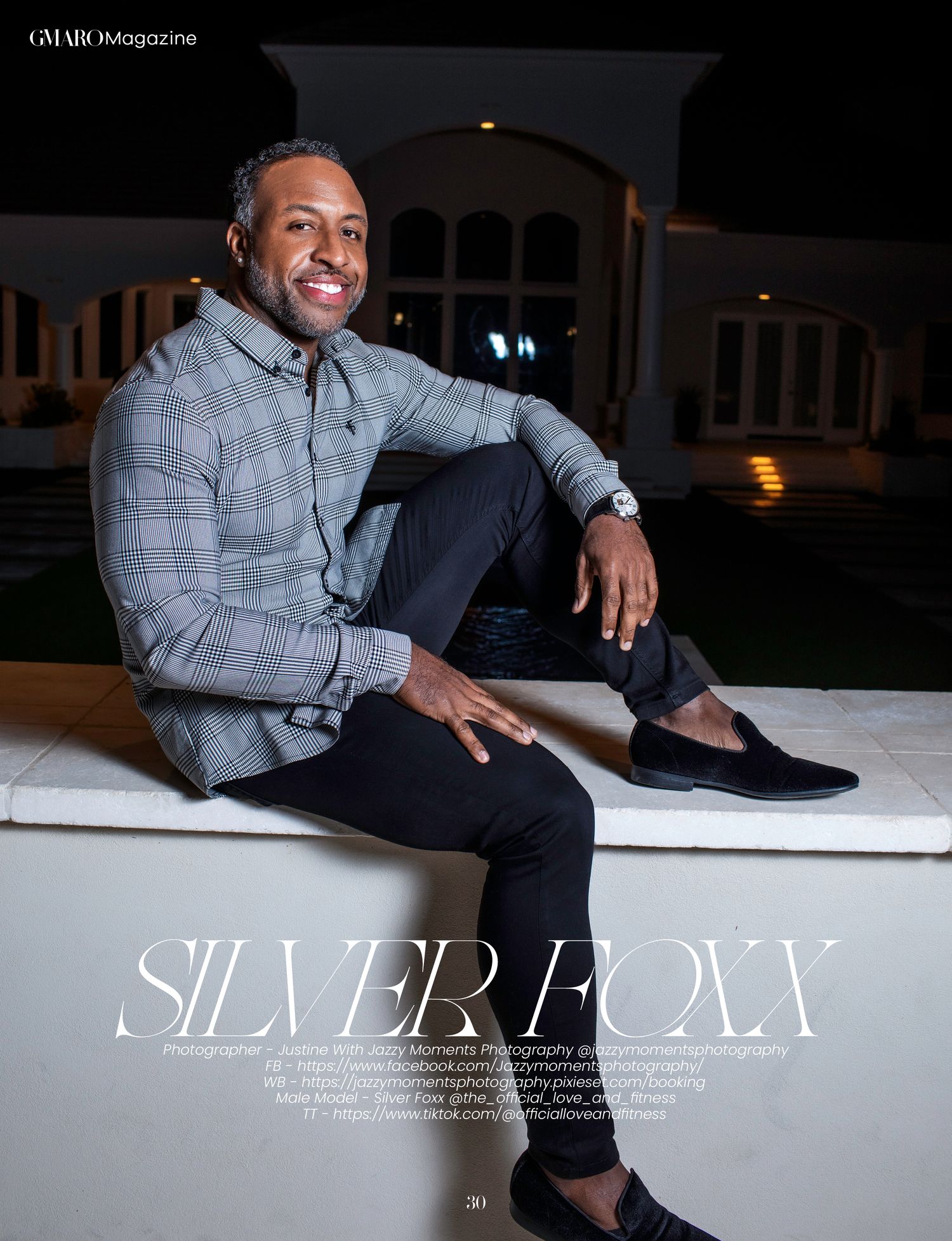 Magazine spread showing model in gray plaid jacket lounging on white surface.