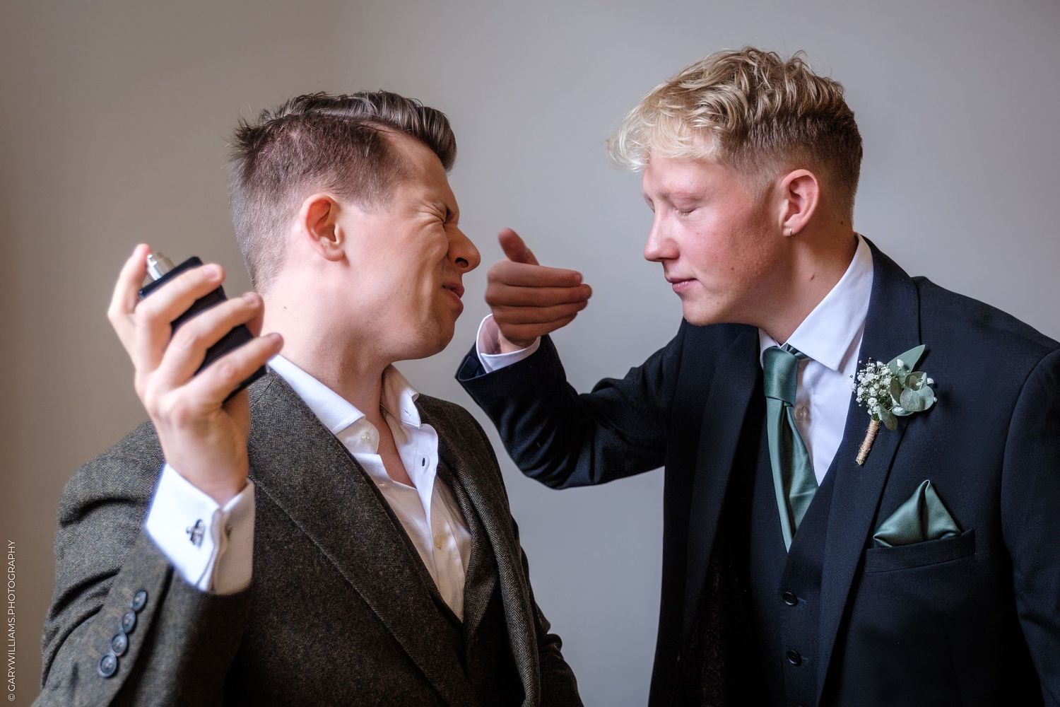 A series of five similar black and white photos showing two people in formal attire having a conversation.