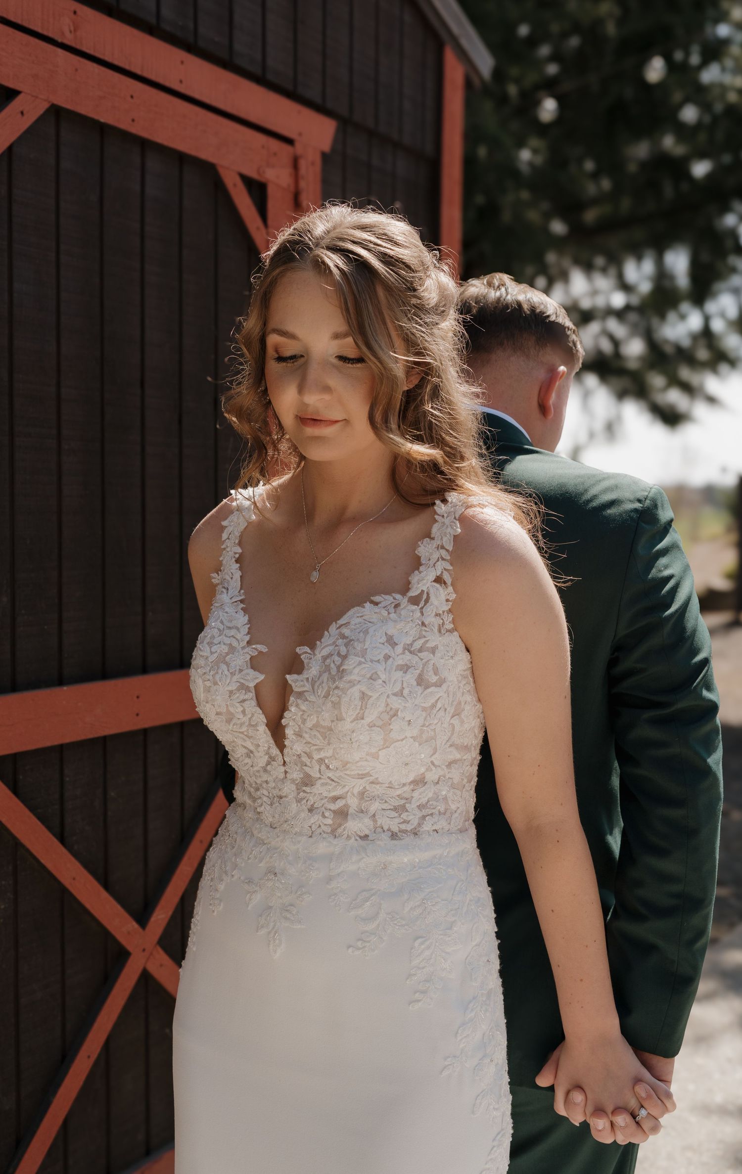 White lace wedding dress detail against dark wooden barn background. Leavenworth, WA
