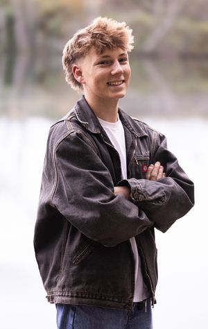 Person wearing a brown leather jacket and white t-shirt poses in multiple candid shots against a blurred background.