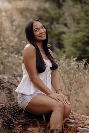 A series of outdoor portrait shots in a natural setting with tall grass and rustic wooden elements.