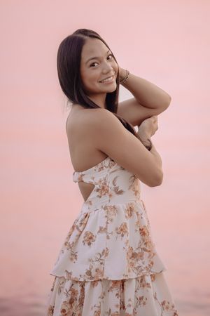 A series of portrait shots against a soft pink backdrop featuring floral print clothing and natural poses.