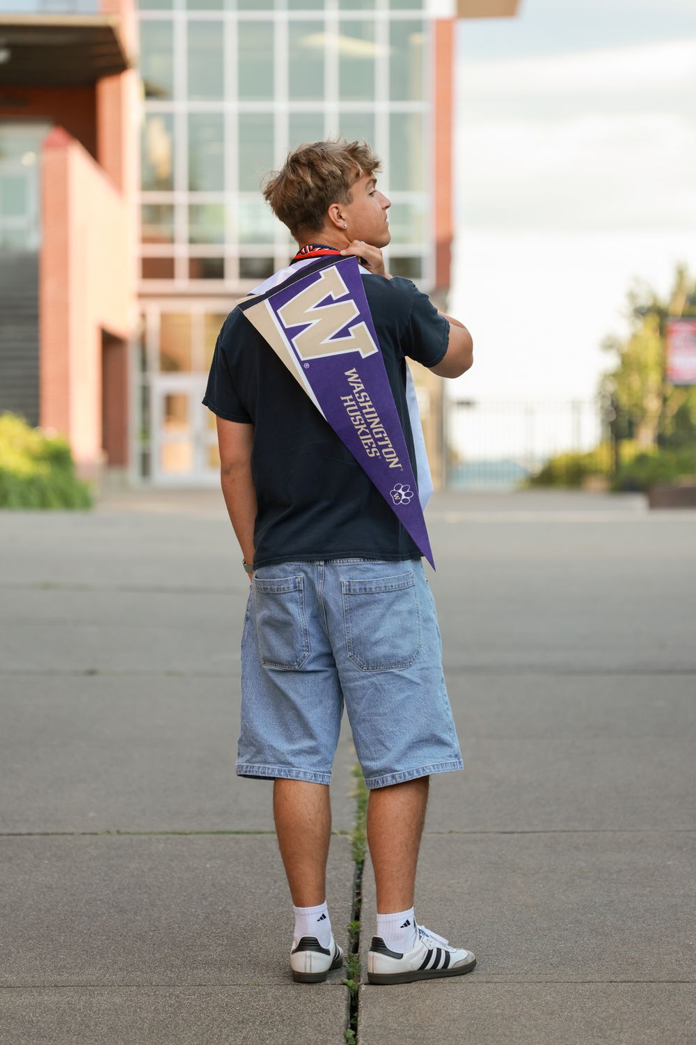 A series of images showing a person in jean shorts and a dark shirt walking away from the camera on a concrete surface.