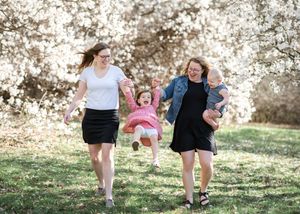 People enjoying a playful moment outdoors in a natural setting during golden hour.