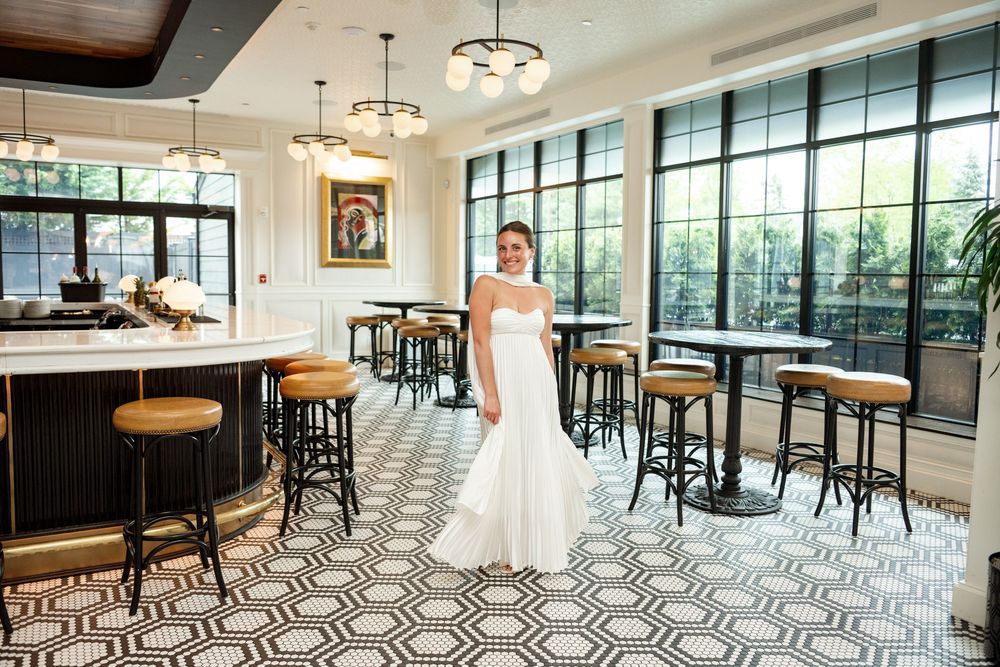 A modern event space with geometric floor tiles, large windows, and pendant lighting creates an elegant atmosphere.