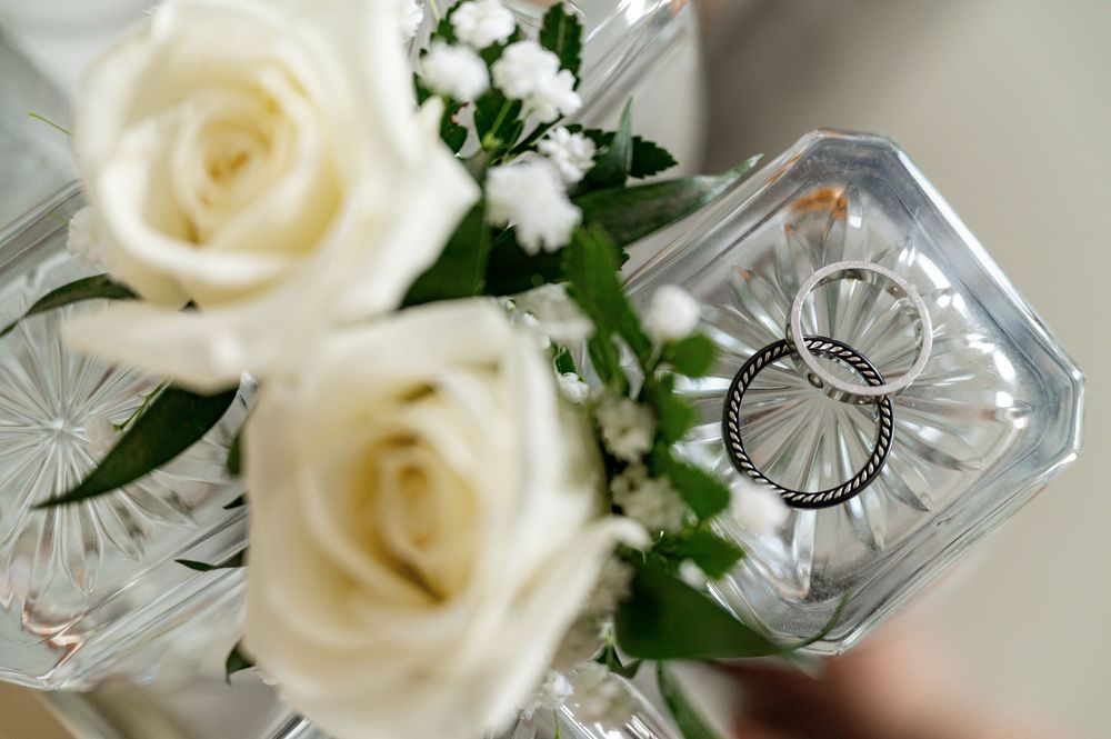 White roses and delicate crystal glassware create an elegant wedding table setting.