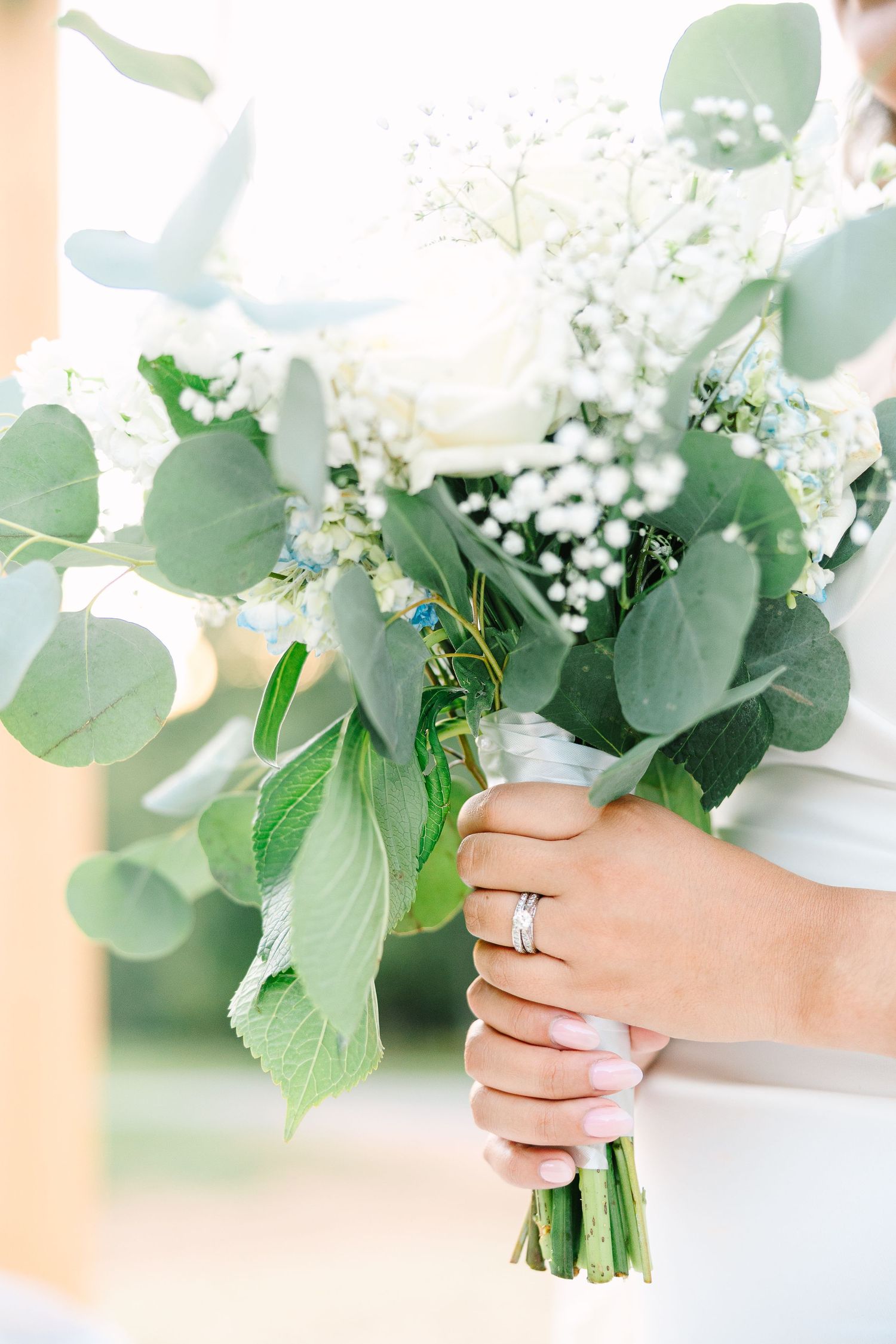 A romantic wedding photo with a classic red brick church backdrop.