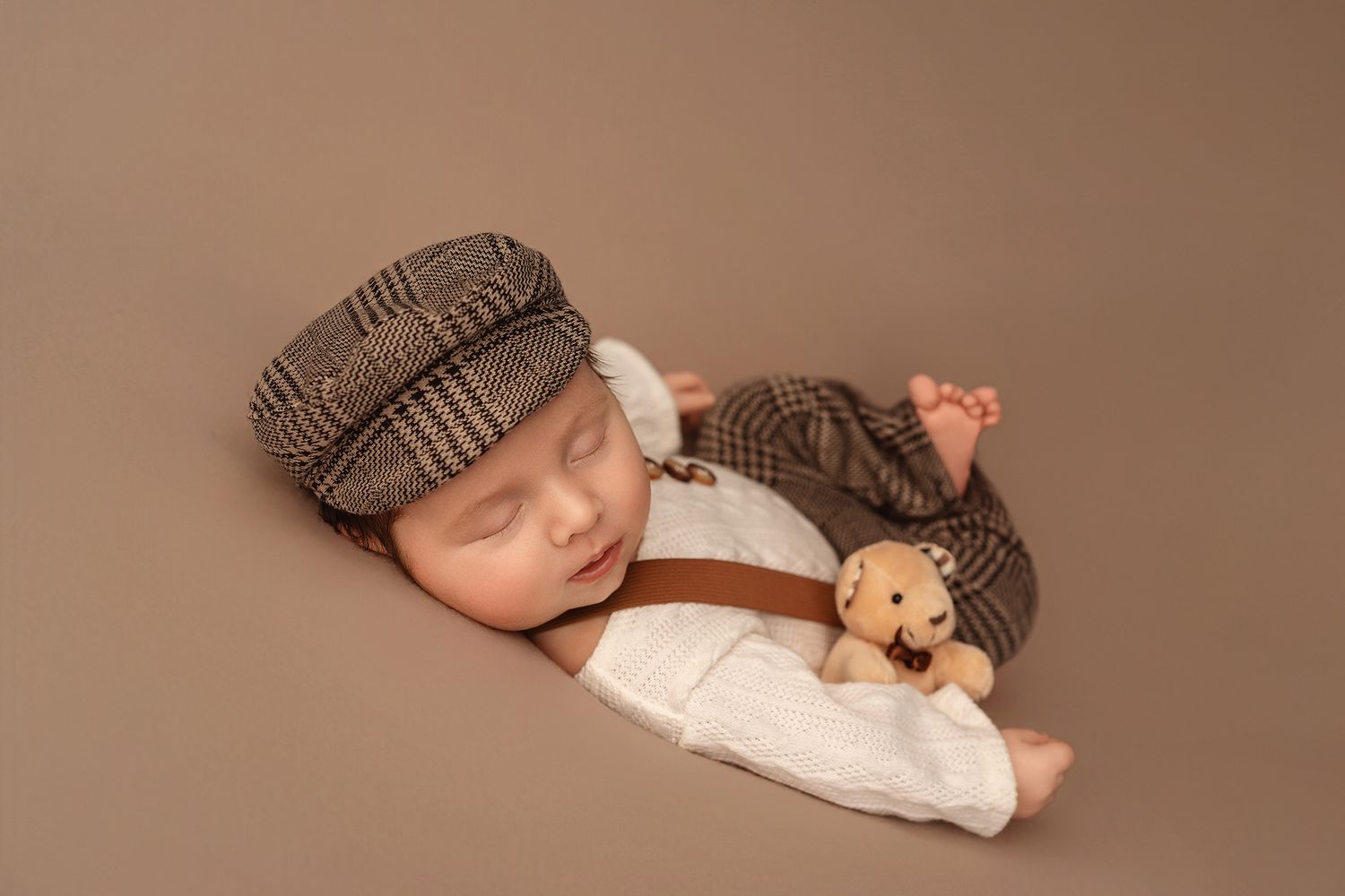Newborn baby on white flokati during newborn session in studio with floral headband