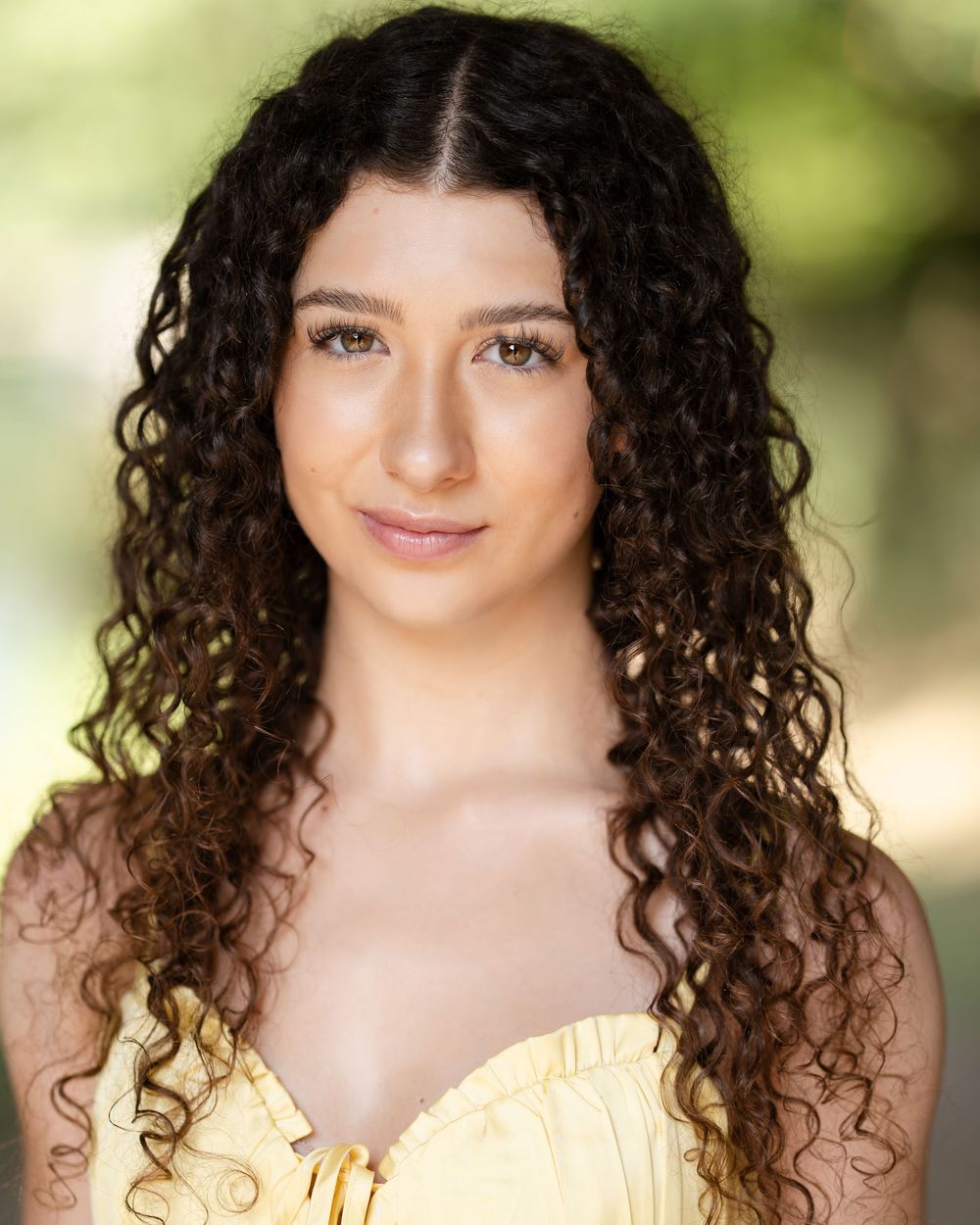 Portrait series showing someone with curly dark hair wearing a yellow top against a soft outdoor background.
