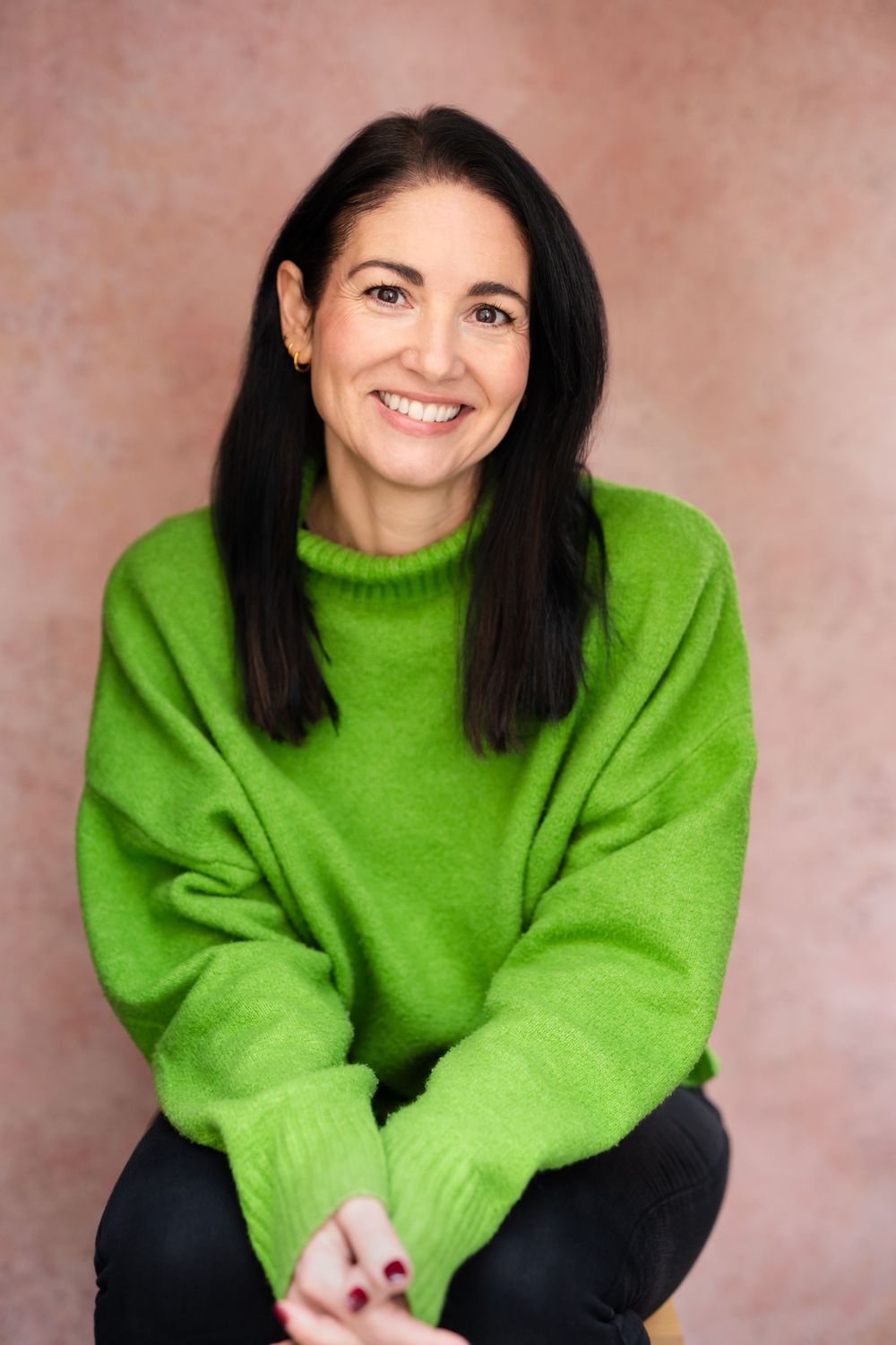 A series of portrait shots showing a person wearing a bright lime green sweater against a pink background.