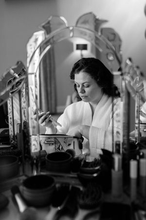 A series of black and white photographs showing a nurse in uniform working in a vintage medical setting.