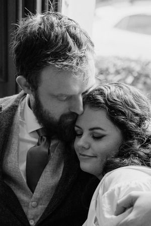 A romantic black and white portrait of a couple sharing an intimate moment together.