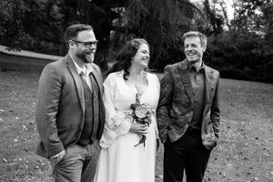 A black and white wedding photo collage showing candid moments of celebration outdoors.