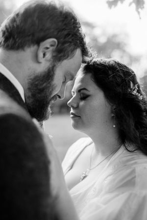 A romantic black and white photo sequence showing a tender moment between a couple on their wedding day.