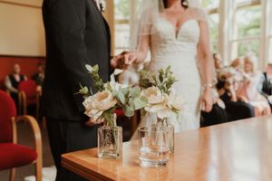 Elegant table settings with floral centerpieces at a wedding reception.