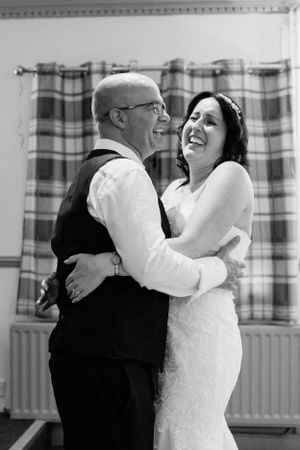 Black and white photo series capturing a couple's romantic dance moves at their wedding celebration.