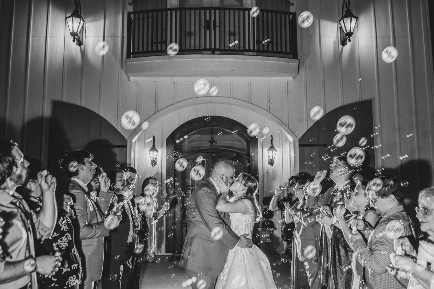 Newlyweds running through bubbles during their wedding grand exit